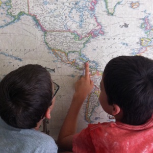 Two of my three boys, finding Haiti on the world map.